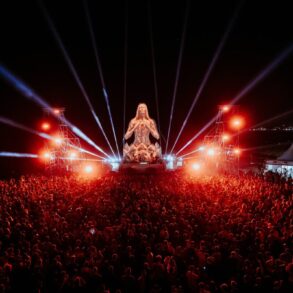 Monumentalna skulptura EXIT to Montenegro festivala osvijetljena zlatnom svjetlošću iznad publike na Velikoj plaži u Ulcinju