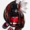 Givenchy L'Interdit Elixir bočica okružena cvijetom tuberoze i svježim trešnjama