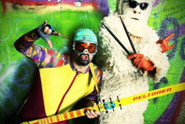Skier & Yeti, beogradski duo, pozira u kostimima skijaša i Yetija sa instrumentima Skitarom i drumsticima ispred grafitima ispisanog zida